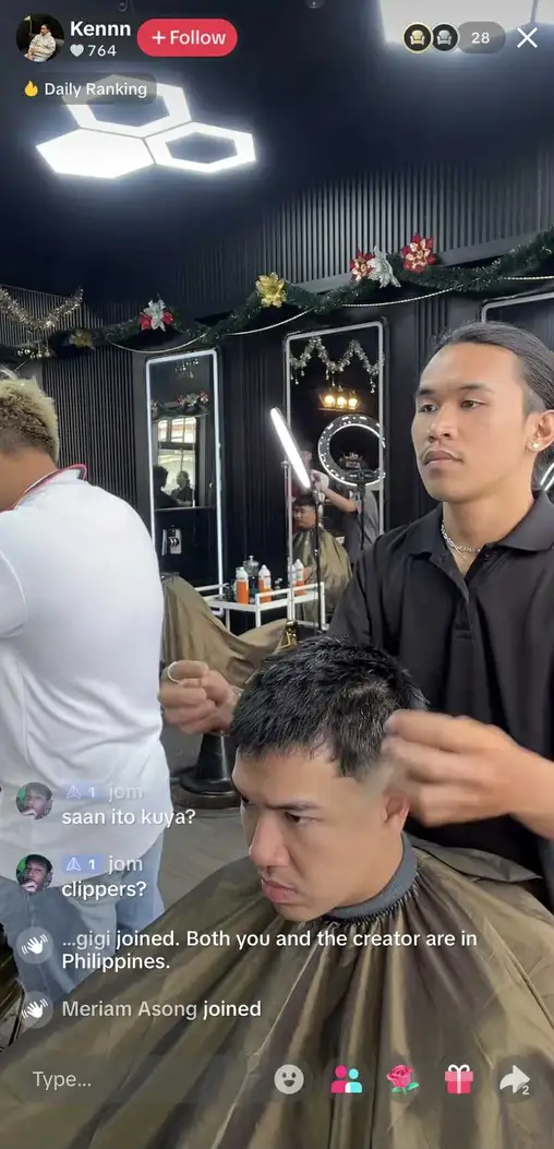 A TikTok live showing behind-the-scenes at a barber shop.