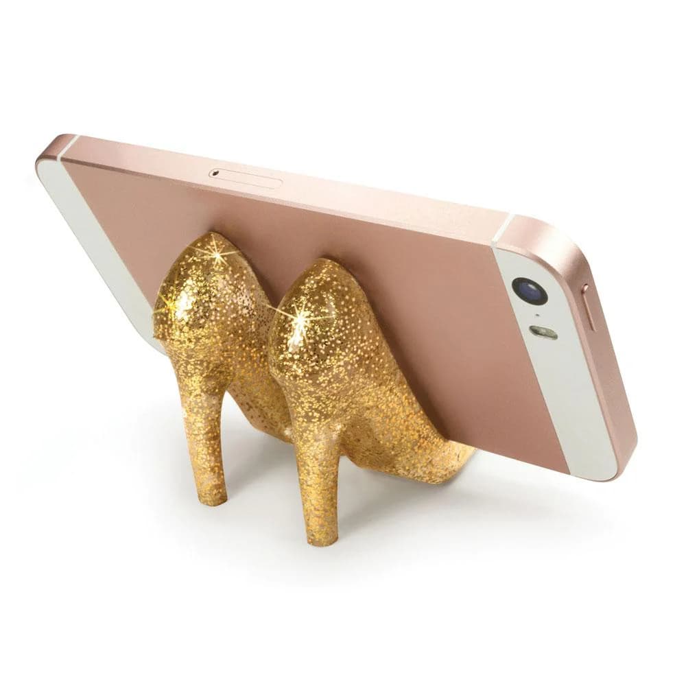 A phone stand shaped like gold high heeled shoes.