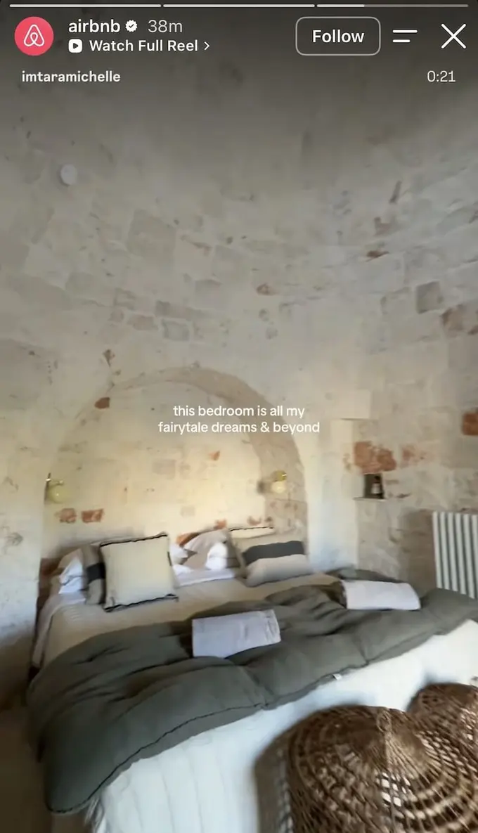 Creator films trullo bedroom with stone vaulted ceiling and linen bedding, fairytale dreams caption overlaid.