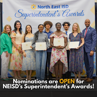 A group of people smiling and holding certificates at the North East ISD Superintendent's Awards ceremony. The mood is celebratory and formal.