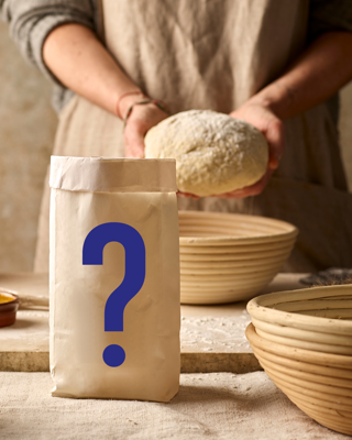 A person prepares bread dough beside a mysterious bag with a question mark. The scene suggests curiosity and experimentation in baking.