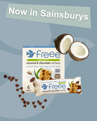 Advertisement for Freee Organic coconut and chocolate oat bars, now available at Sainsbury's. The scene includes product packaging, chocolate chips, and a halved coconut on a blue background.