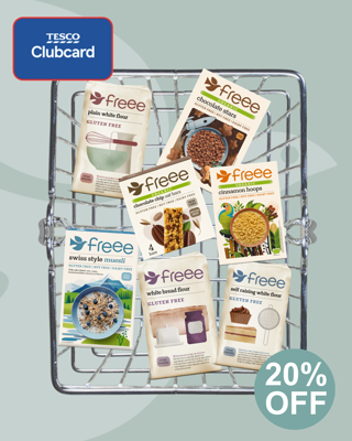 An arrangement of Freee by Doves Farm gluten-free products in a shopping basket, with a Tesco Clubcard promotion offering 20% off. The image appears bright and inviting, emphasizing healthy and gluten-free grocery options.