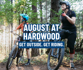 A joyful moment of mountain biking in the woods featuring a parent and child wearing helmets. Bright text overlays highlight outdoor adventure.